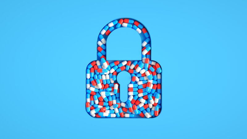 Illustration of a padlock made of red, white, and blue pills, symbolizing access barriers to medication-assisted treatment despite research showing its effectiveness.