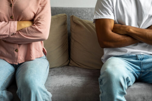 Couple having a disagreement at home, trapped in the anxious avoidant dynamic