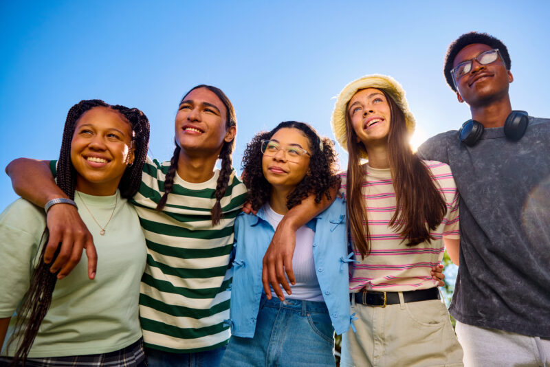 Group of teenagers standing together outside, representing how opioid use disorder increasingly affects adolescents and the urgent need for youth prevention and support.