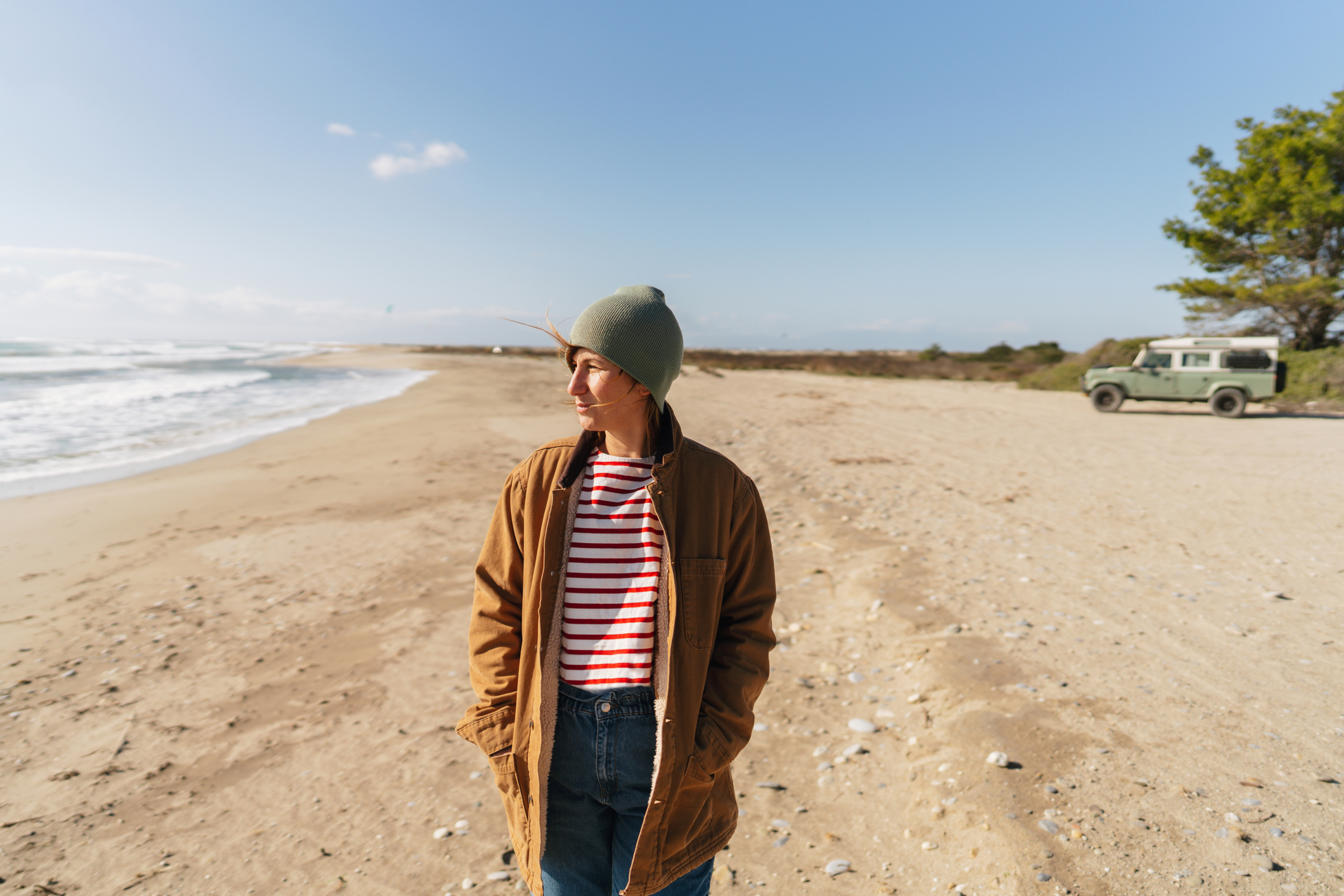 A person walks alone on a quiet beach, reflecting the isolation and emotional weight often linked to reactive depression.