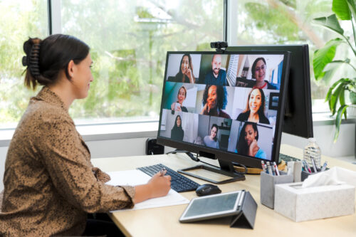 Woman attends a virtual group therapy session with Charlie Health peers. Online teamwork and communication.