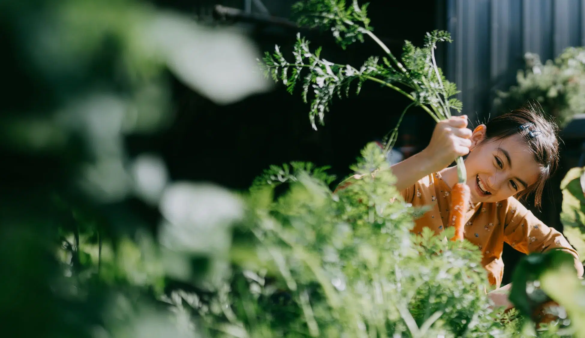 Child smiling outdoors in a garden