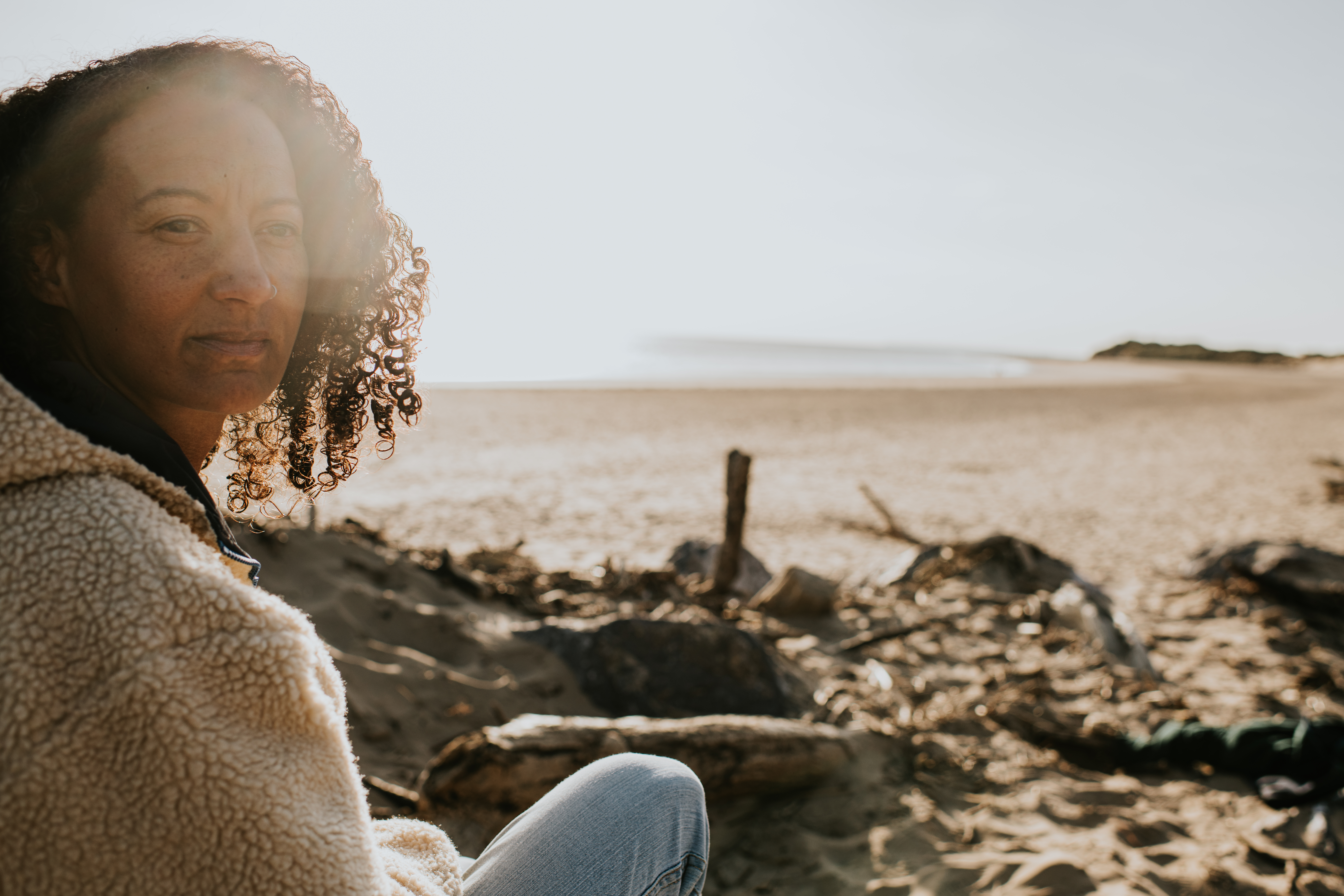 Lady on beach reflecting about her Charlie Health experience and BPS experience