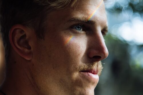Blond with a mustache thinking and smiling, subtly.